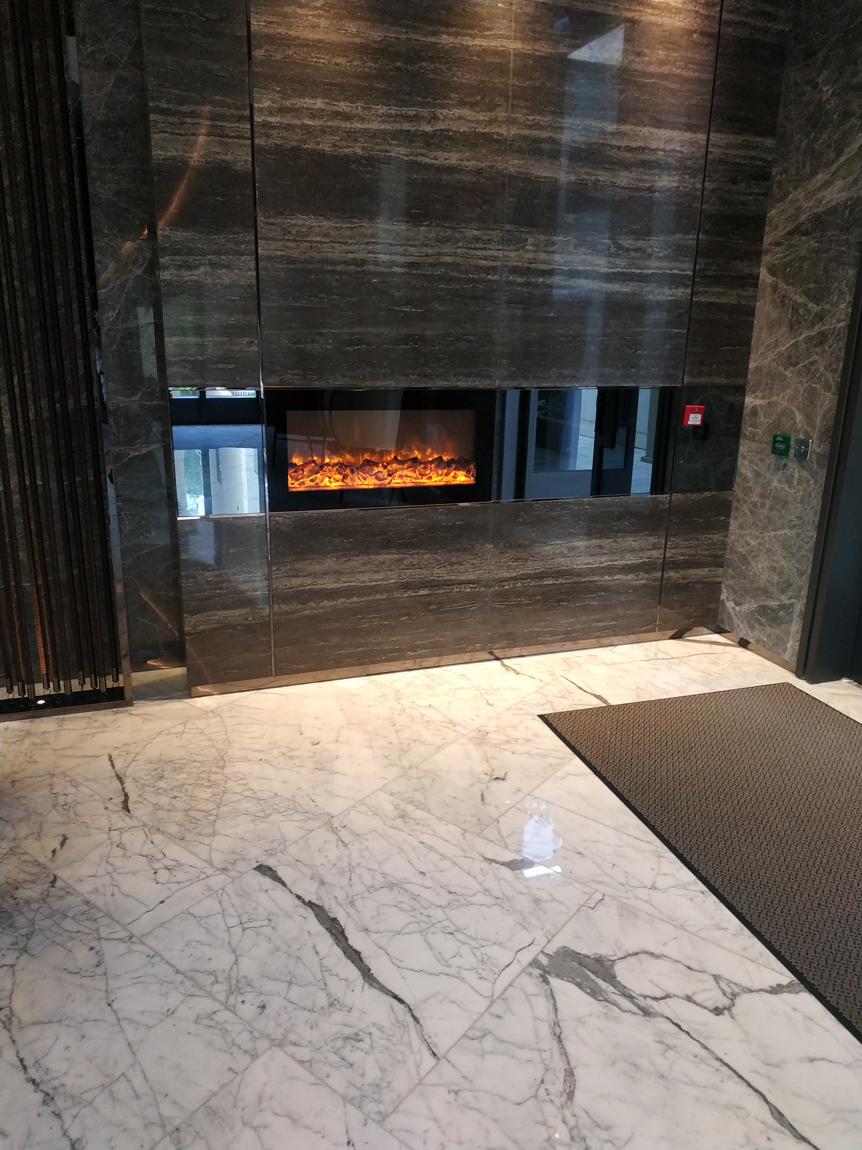 Golf Eden Manor clubhouse electric fireplace · dark stone wall · BB Fires